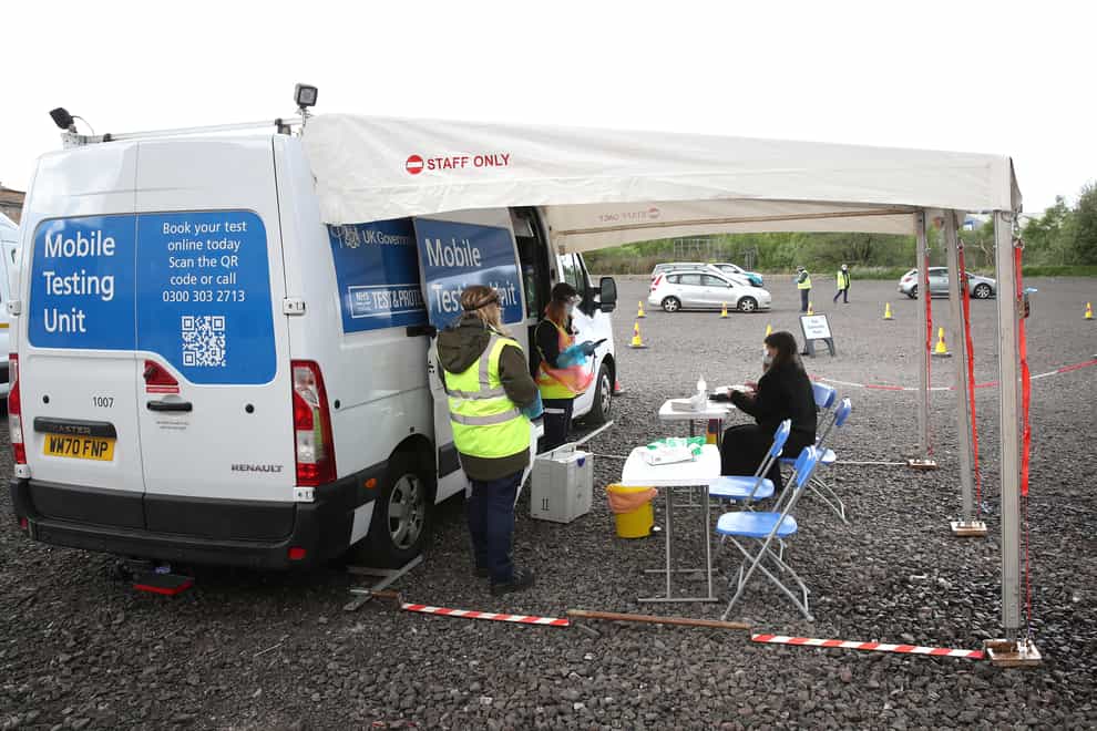 Staff from the Scottish Ambulance Service run a Covid mobile testing unit from a car park in the Pollokshields area of Glasgow (Andrew Milligan/PA)