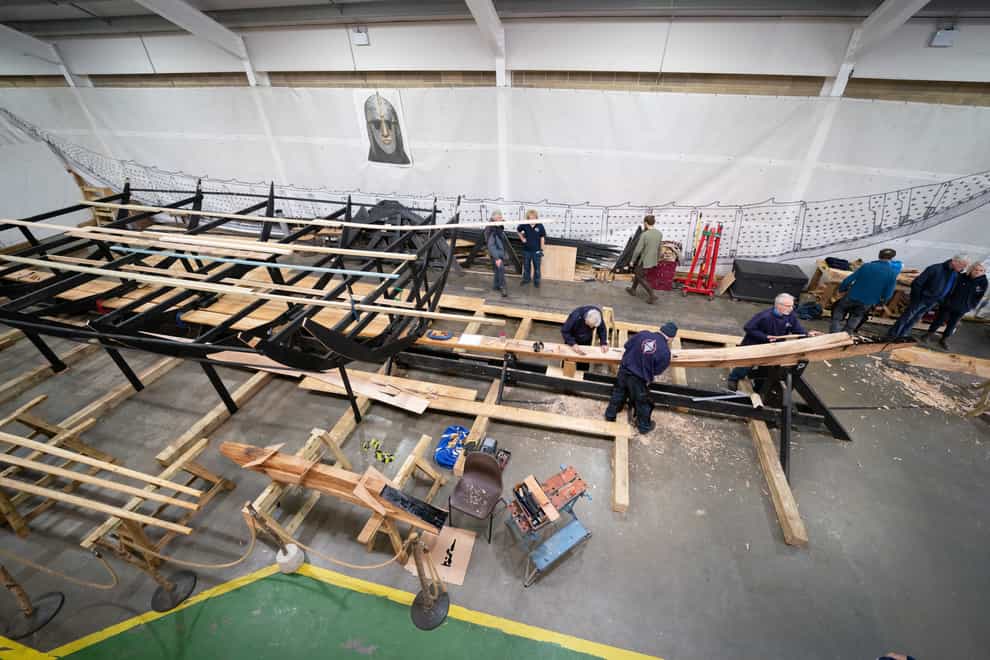 A team of volunteers work on the keel (Joe Giddens/PA)