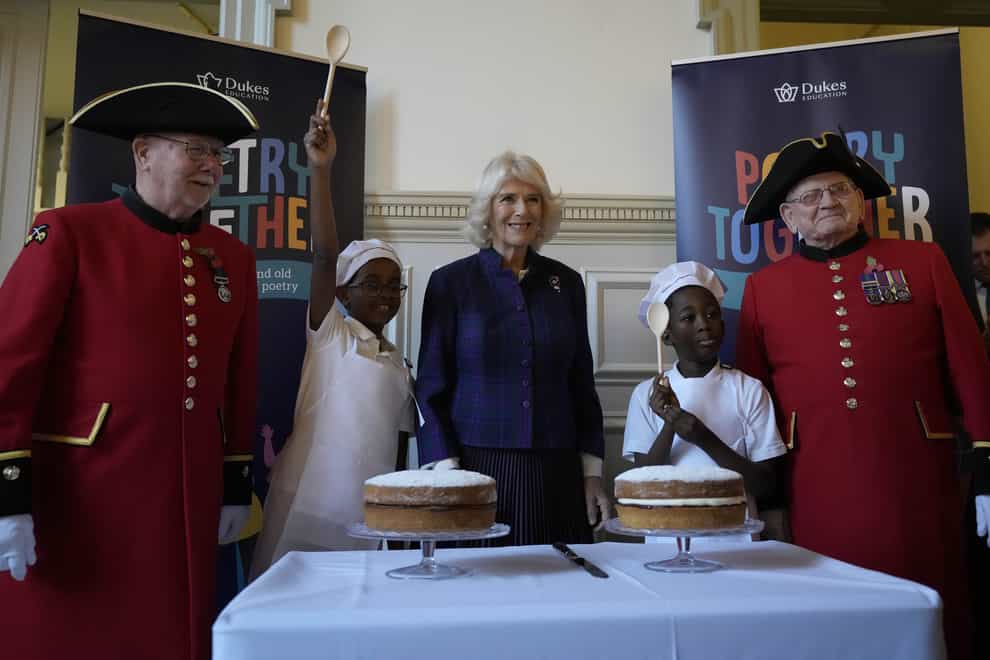 The Duchess of Cornwall, centre, with children and Chelsea Pensioners during the recital (Frank Augstein/PA)