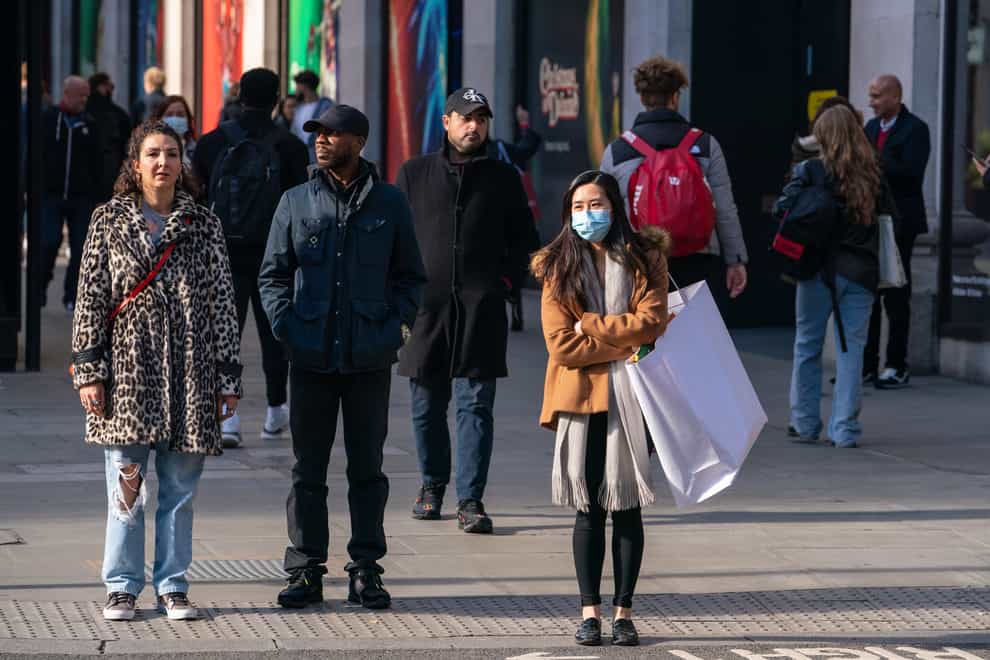 Shoppers wearing face masks on Oxford Street in central London (Dominic Lipinski/PA)