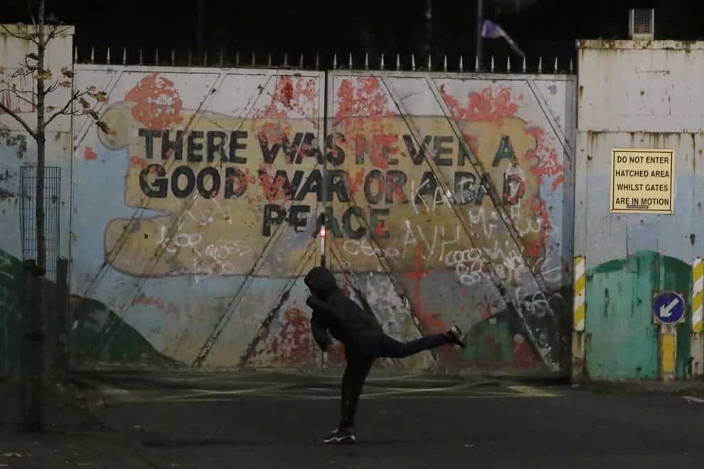 A protester on Lanark Way in the Loyalist Shankill Road area close to the peace wall (Brian Lawless/PA)
