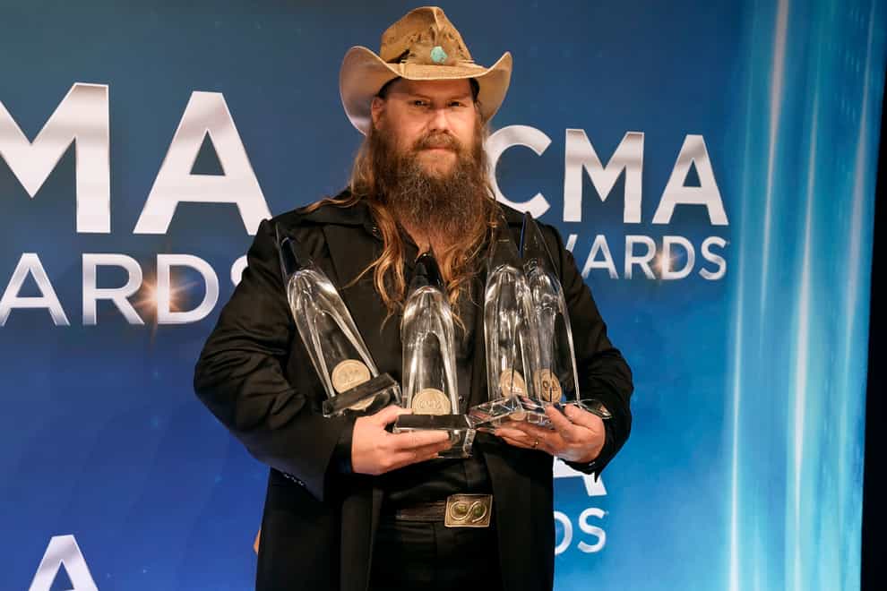 Chris Stapleton with the awards for entertainer of the year, male vocalist of the year, and album of the year at the 55th annual CMA Awards at the Bridgestone Arena in Nashville, Tennessee (Ed Rode/AP)