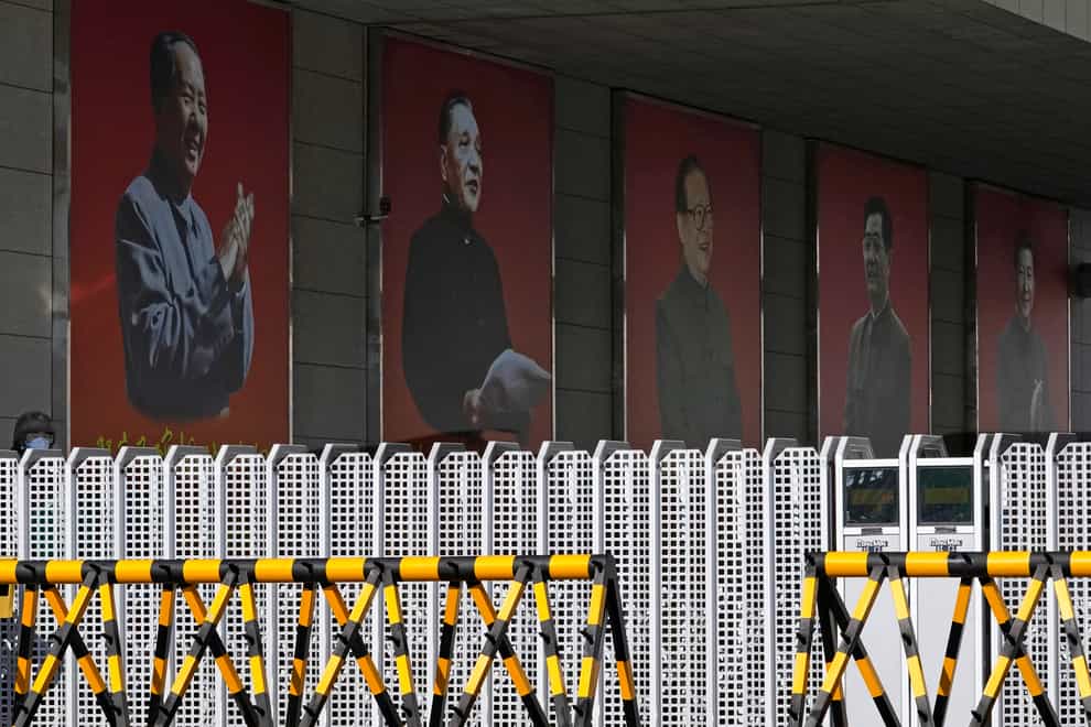 Portraits of China’s former top leaders Mao Zedong, left to right, Deng Xiaoping, Jiang Zemin, Hu Jintao and President Xi Jinping at a military camp in Beijing (Ng Han Guan/AP)
