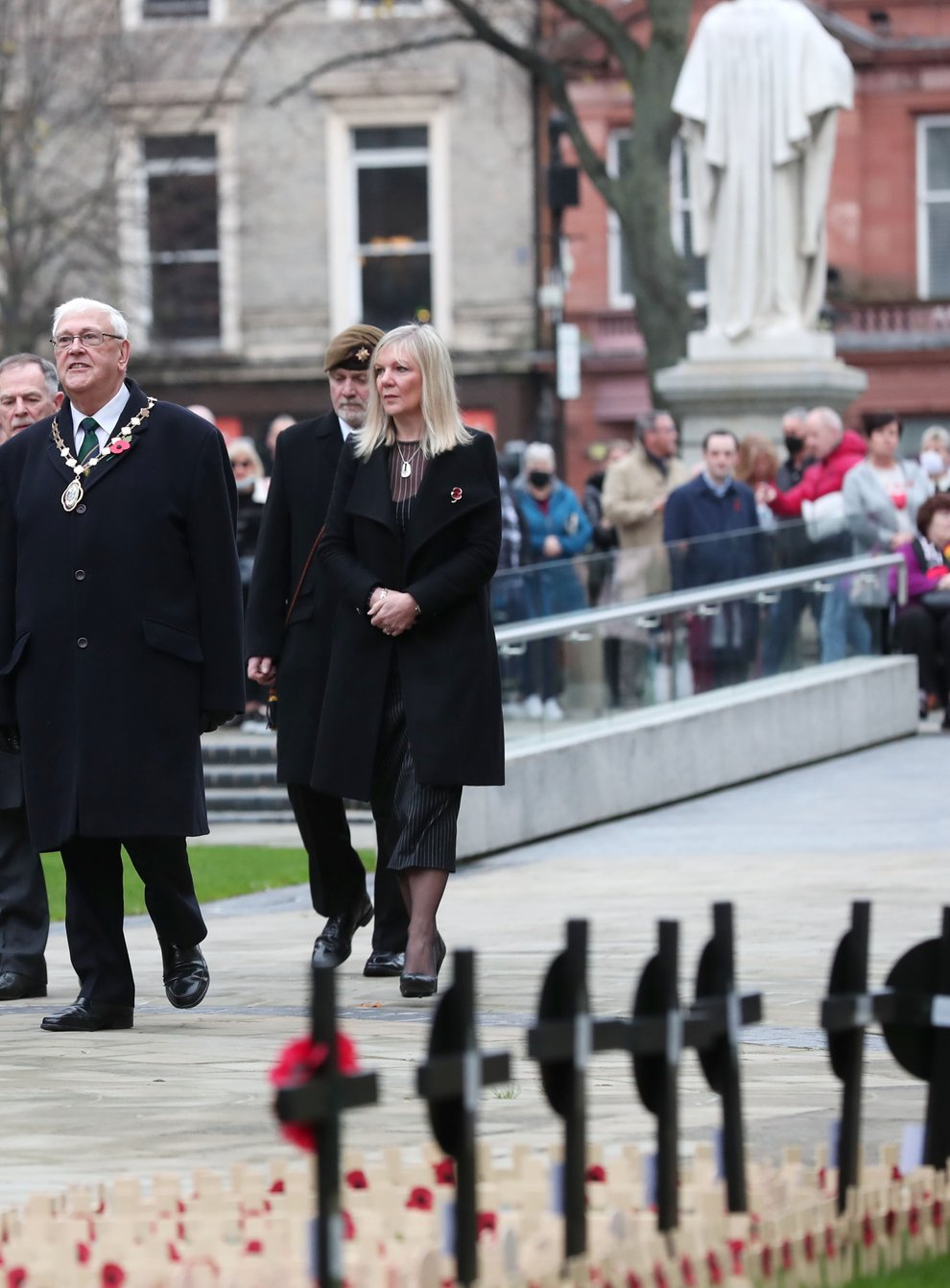 Deputy Lord Mayor of Belfast, Alderman Tom Haire, centre, Belfast councillor Michael Long and chief executive of Belfast City Council Suzanne Wylie during a two-minute silence at City Hall, Belfast, for Armistice Day (PressEye/PA)