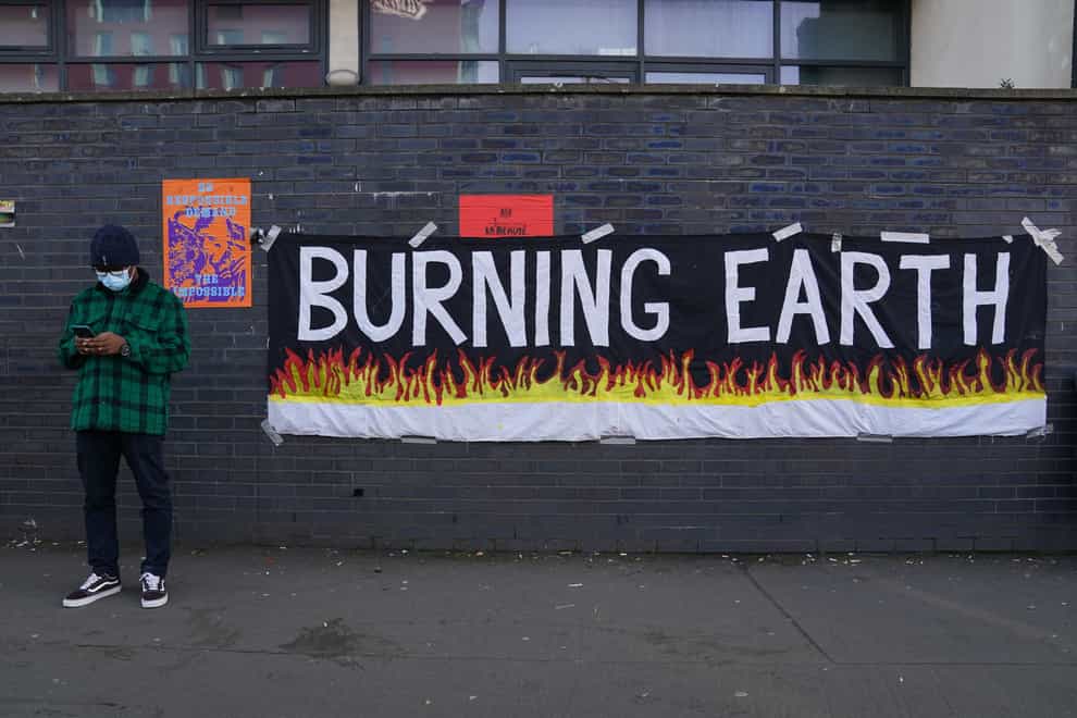 A banner on a wall near Cop26 (Andrew Milligan/PA)