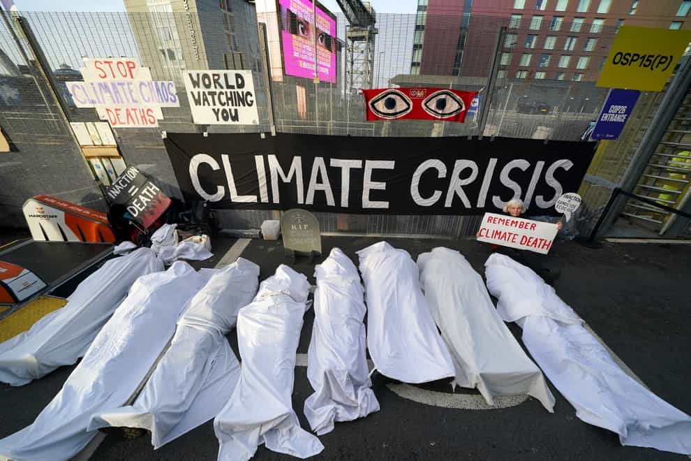 Climate activists dressed as shrouded bodies take part in a protest outside the Cop26 summit (Andrew Milligan/PA)