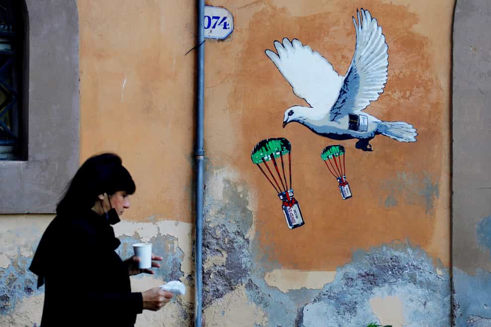 A mural depicting a vaccine in Rome (AP)