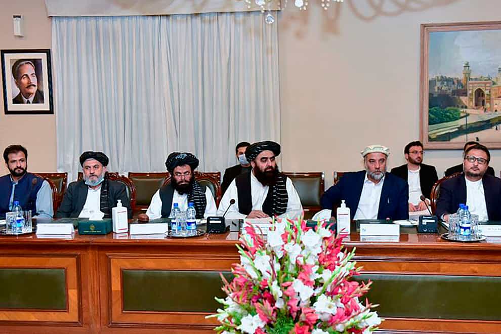 An Afghan delegation led by Amir Khan Muttaqi, attends a meeting with Pakistan’s foreign minister Shah Mahmood Qureshi, in Islamabad (Pakistan Ministry of Foreign Affairs/AP)