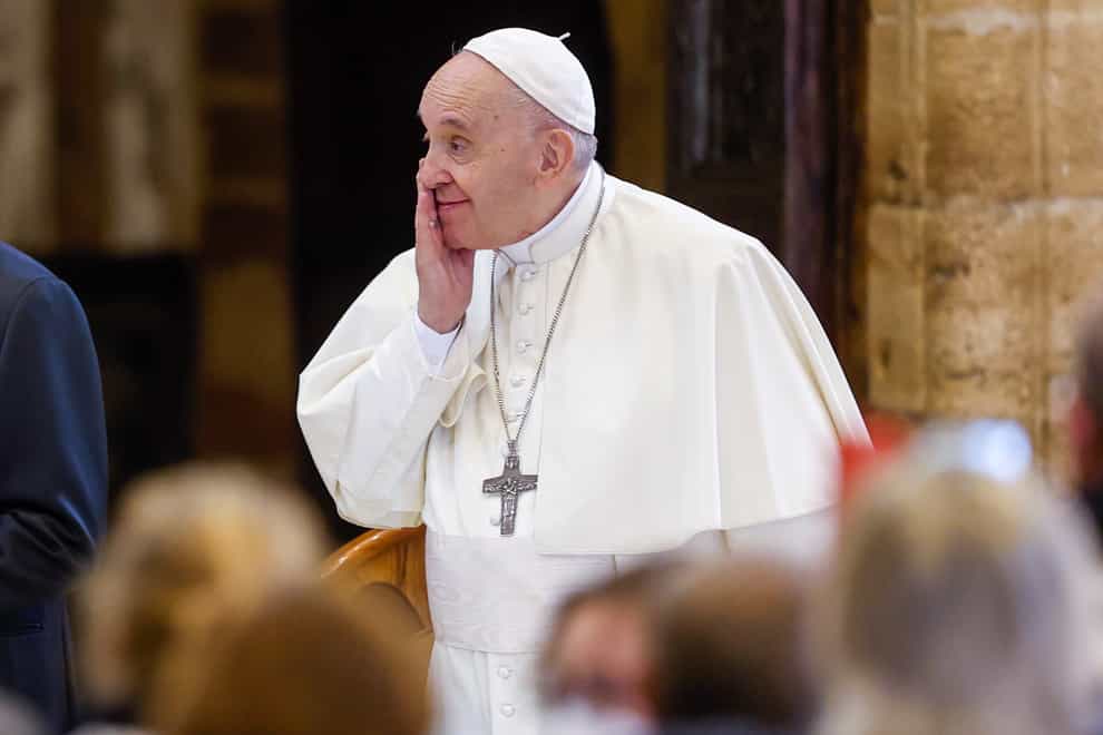 Pope Francis attends a meeting of listening and prayer inside the Basilica of Santa Maria degli Angeli in Assisi, central Italy, Friday, Nov. 12, 2021. Pope Francis met a group of 500 poor people from different parts of Europe ahead of the fifth World Day of the Poor on Sunday. (AP Photo/Riccardo De Luca)