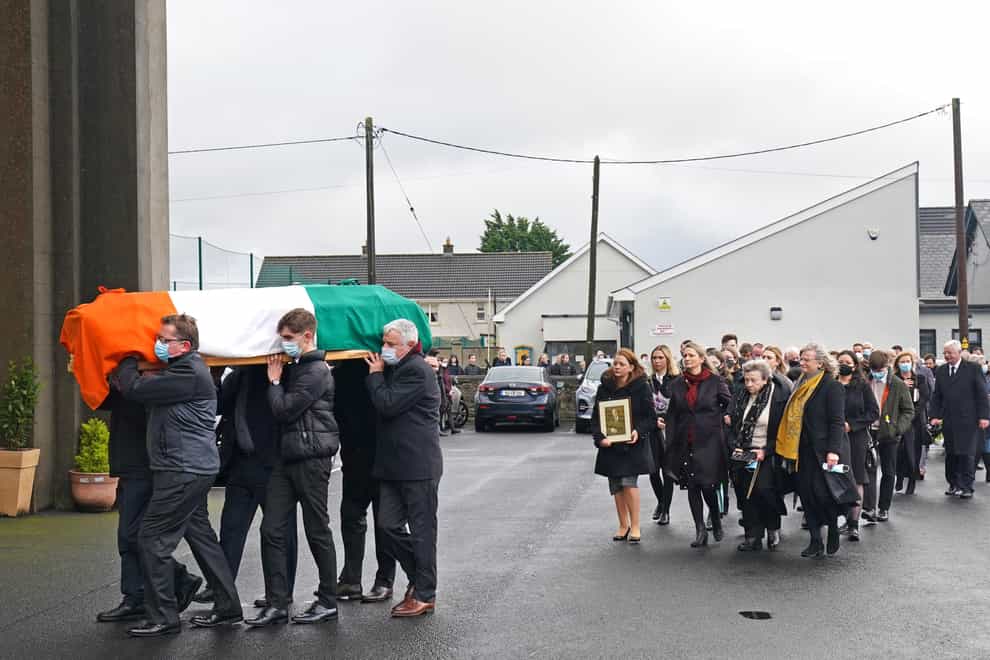 The coffin of Austin Currie is carried into the Church of the Immaculate Conception in Allenwood, Co. Kildare, for Requiem Mass (Brian Lawless/PA)