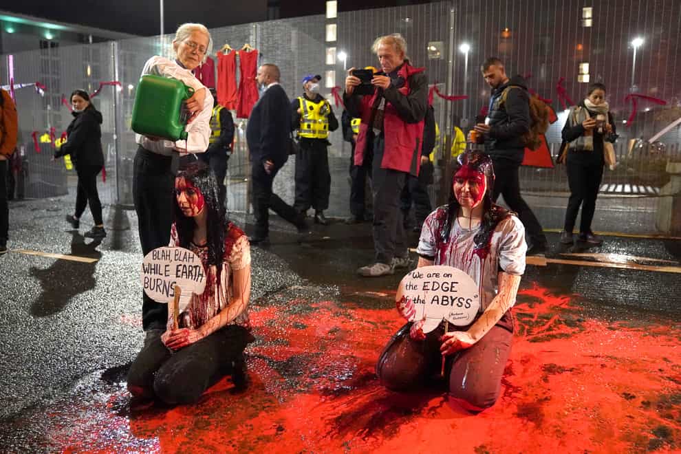 Climate activists protesting in fake blood during the official final day of the Cop26 summit in Glasgow (Andrew Milligan/PA)