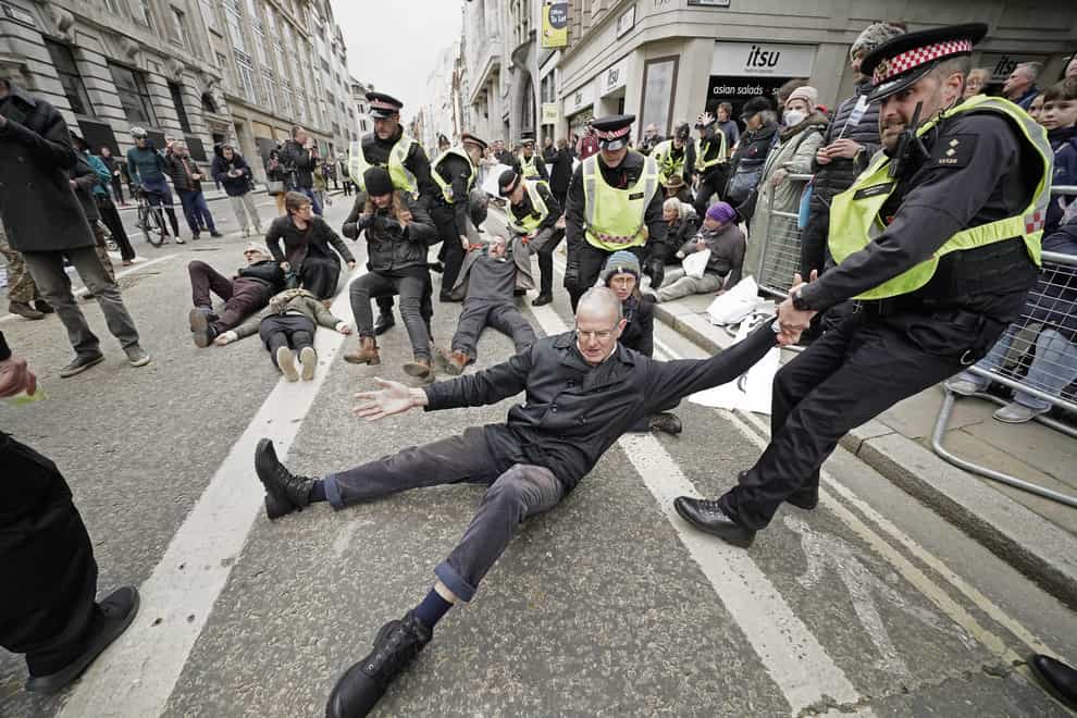 Police remove Extinction Rebellion protesters during the Lord Mayor’s Show parade in the City of London (Aaron Chown/PA)