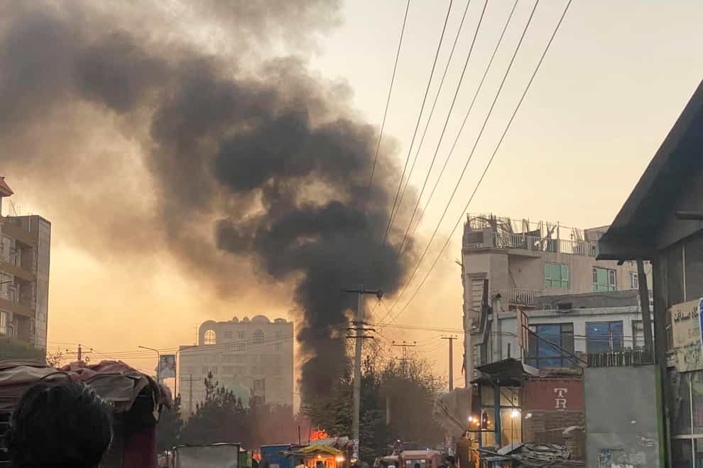 Smoke rises following the bomb blast in Kabul (AP)