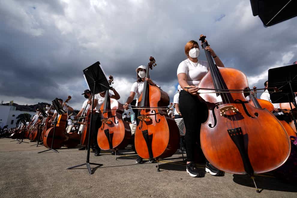 Members of the National Orchestra System gather to try and break a Guinness World Record for most instruments used in a piece of music, in Caracas, Venezuela (Ariana Cubillos/AP)