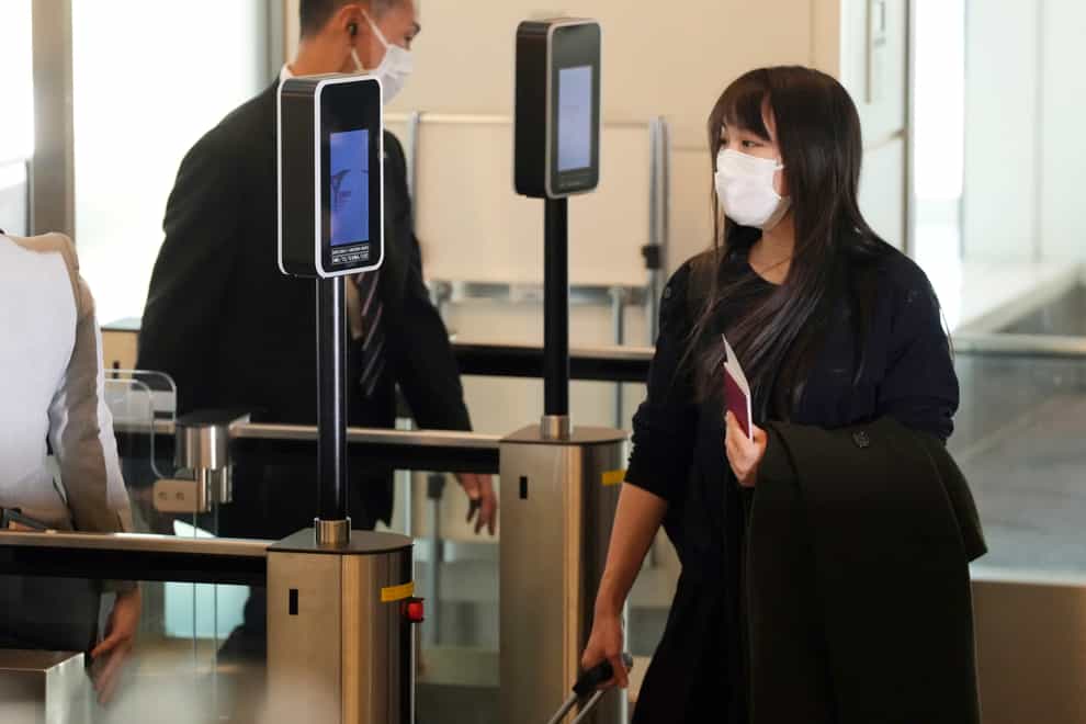 Japan’s former princess Mako Komuro prepares to board the plane to New York (Eugene Hoshiko/AP)