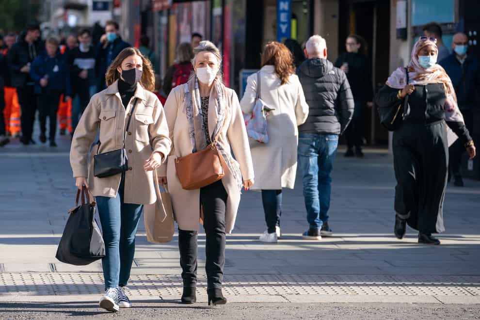 Shoppers wear face masks on Oxford Street in central London (Dominic Lipinski/PA)