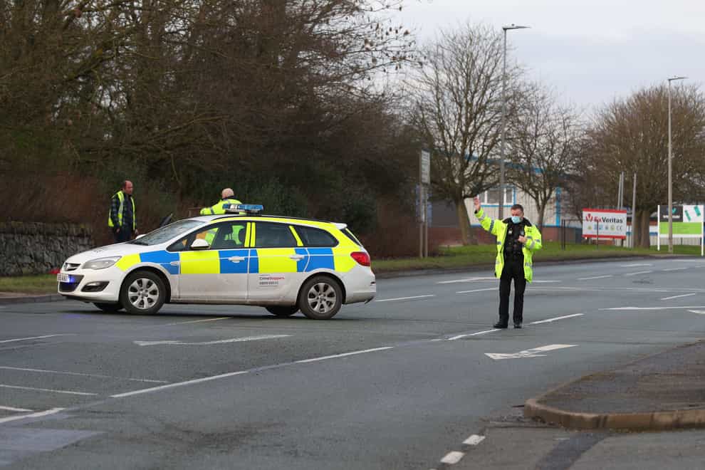 Police officers outside the Wockhardt pharmaceutical manufacturing facility, a production plant for the coronavirus vaccine, on Wrexham Industrial Estate, North Wales, where a suspect package is being investigated. Picture date: Wednesday January 27, 2021.