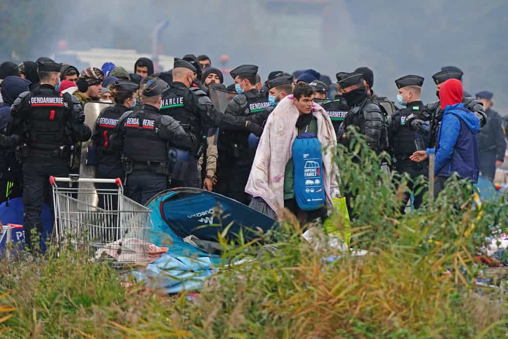 Migrants at a makeshift camp on the site of a former industrial complex in Grande-Synthe, east of Dunkirk (Gareth Fuller/PA)