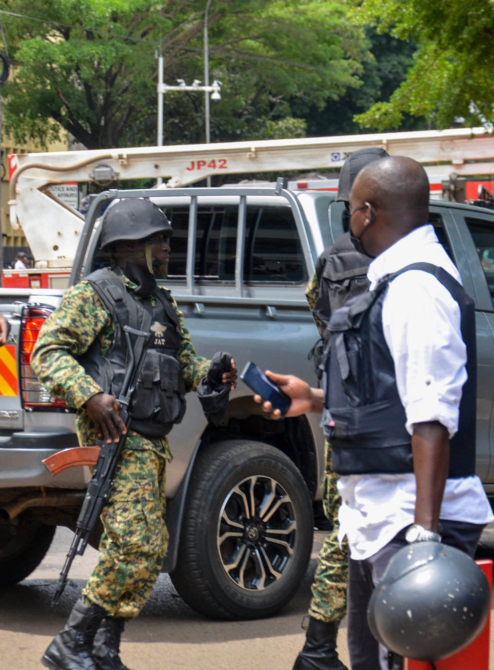 Security forces secure the scene of a blast on a street near the parliamentary building in Kampala, Uganda, Tuesday, Nov. 16, 2021. Two loud explosions rocked Uganda’s capital, Kampala, early Tuesday, sparking chaos and confusion as people fled what is widely believed to be coordinated attacks. (AP Photo/Ronald Kabuubi)