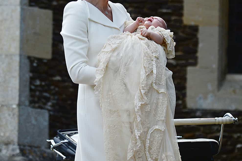 The Duchess of Cambridge carries Princess Charlotte (PA)