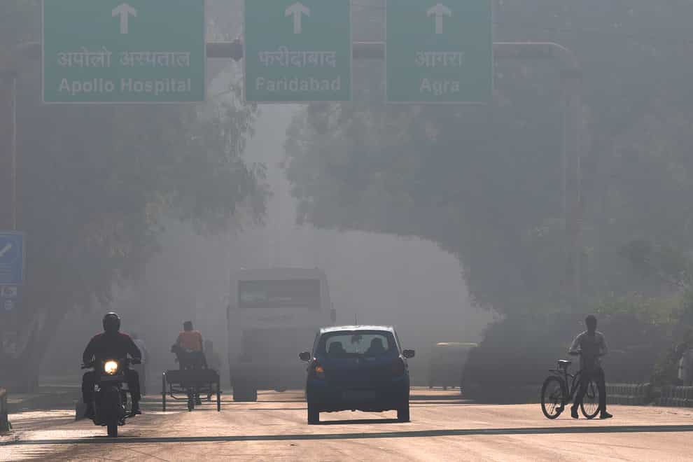 Motorists drive amidst morning haze and smog in New Delhi, India (Manish Swarup/AP)