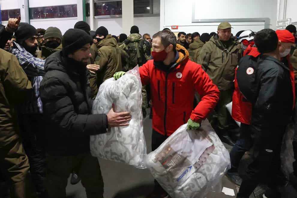 Migrants in a logistics centre at the Belarus/Poland border near Grodno (Maxim Guchek/BelTA via AP)