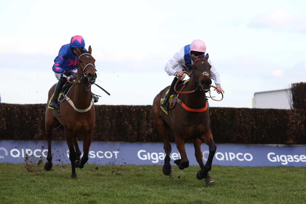 Waiting Patiently and Brian Hughes (right) lead Cue Card and Paddy Brennan away from the last fence before going on to win The Betfair Ascot Steeple Chase (Julian Herbert/PA)