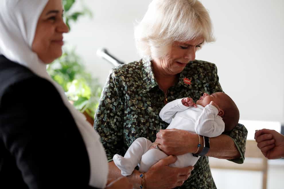 The Duchess of Cornwall holds baby girl Sarah Abu Ameerah (Peter Nicholls/PA)