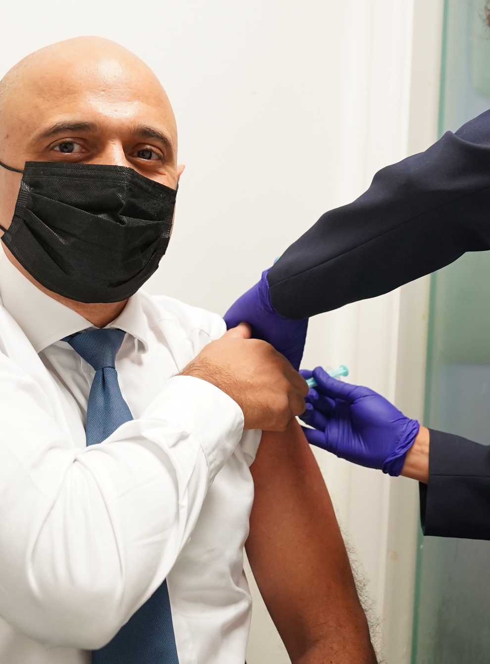Health Secretary Sajid Javid receives his Covid-19 booster jab from Nikki Kanani, Medical director primary care NHS England, at a pharmacy in central London (PA)