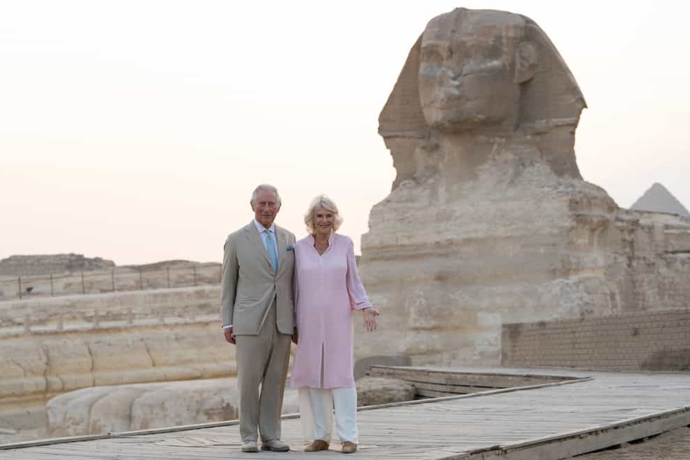 The Prince of Wales and The Duchess of Cornwall pose in front of the Sphinx during their visit to Egypt (Joe Giddens/PA)