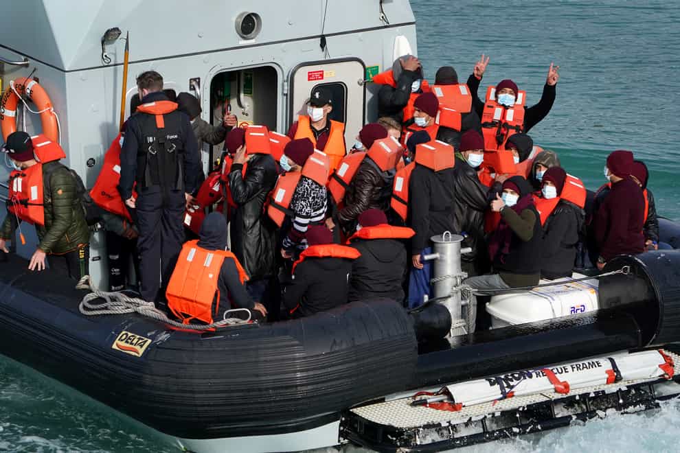 A group of people thought to be migrants are brought in to Dover by Border Force officers (Gareth Fuller/PA)