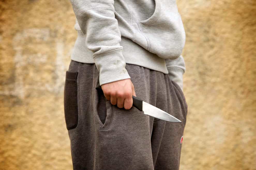 PICTURE POSED BY MODEL. A youth with a knife, as the number of people carrying knives has fallen to a nine-year low, according to the figures released by the Government in a Parliamentary answer to Nationalist backbencher Stuart McMillan.