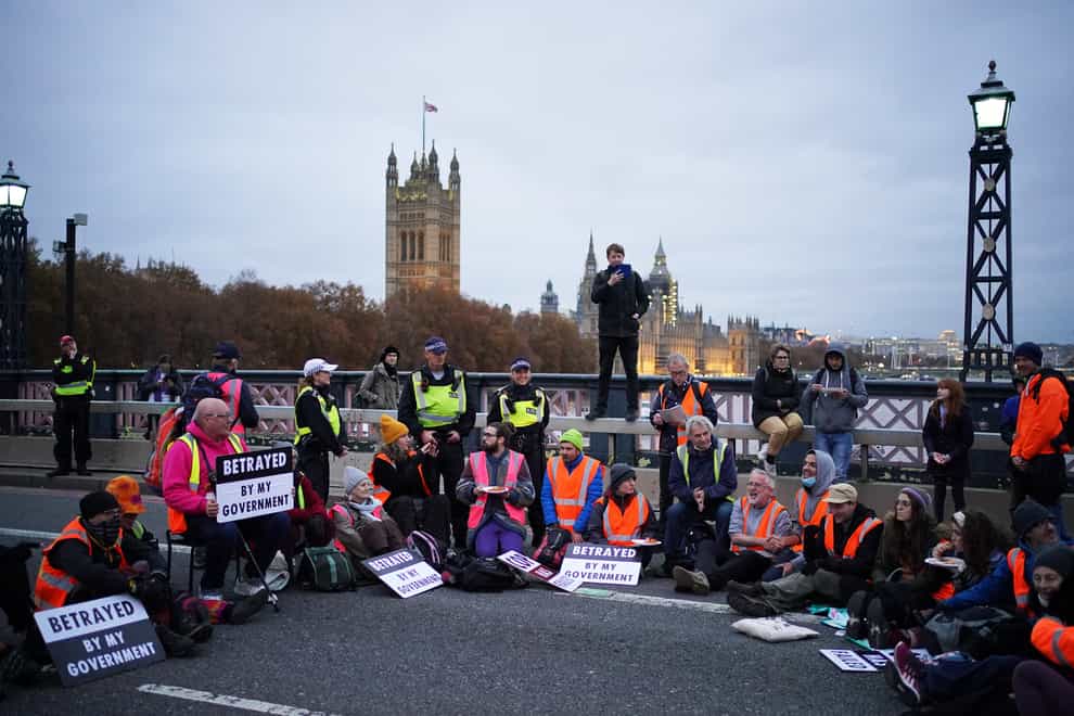 Supporters of the nine jailed Insulate Britain climate activists take part in a demonstration on Lambeth Bridge (Dominic Lipinski/PA)
