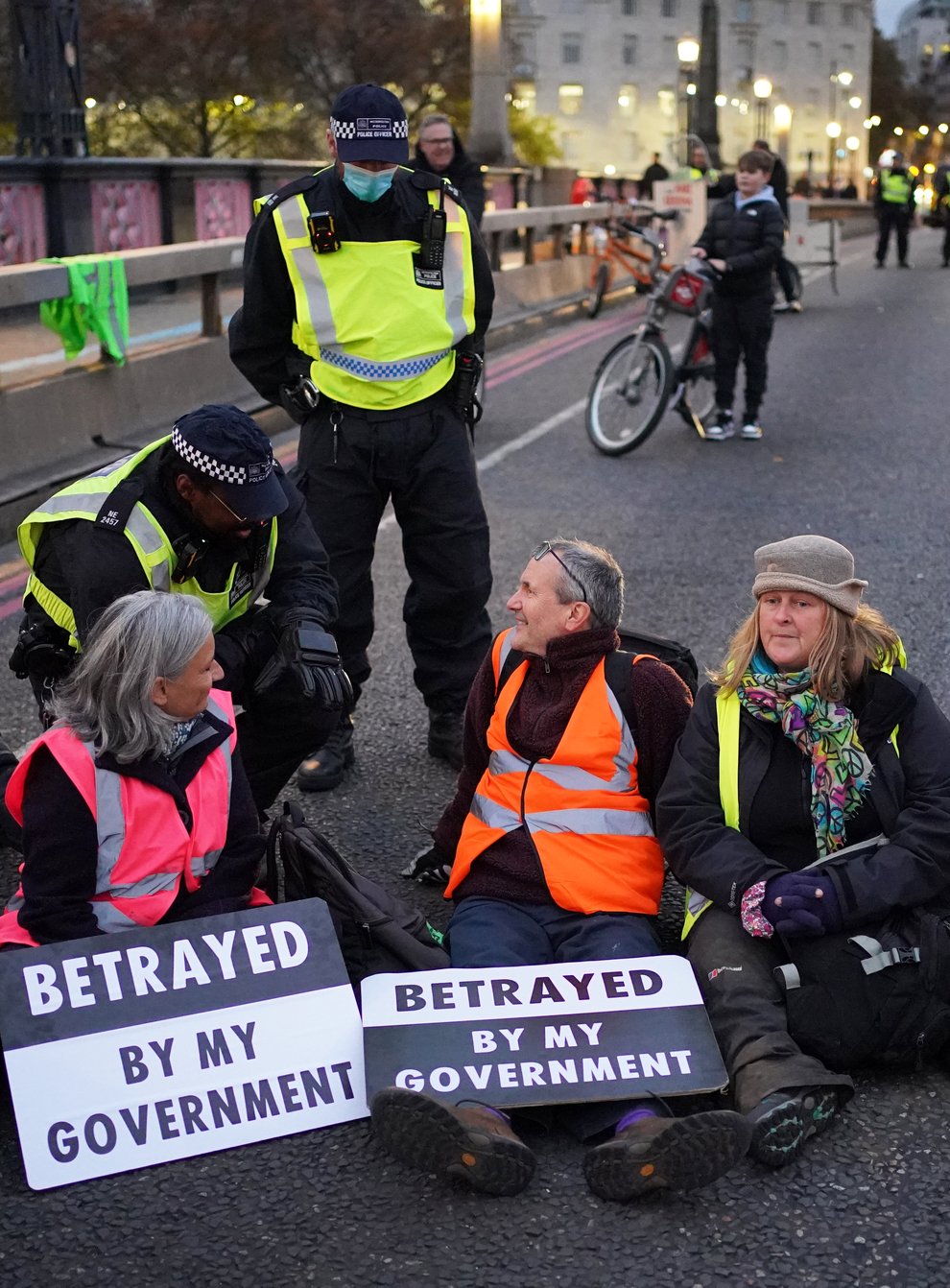 Supporters of the nine jailed Insulate Britain climate activists take part in a demonstration on Lambeth Bridge (Dominic Lipinski/PA)