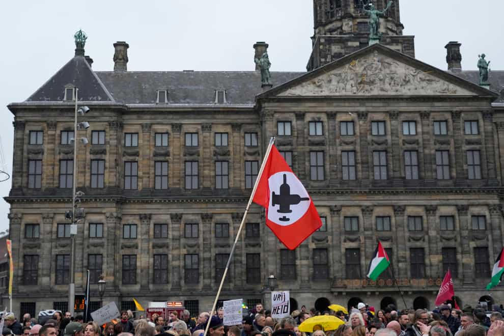 People gather on Dam Square in front of the Royal Palace in Amsterdam (Peter Dejong/AP)