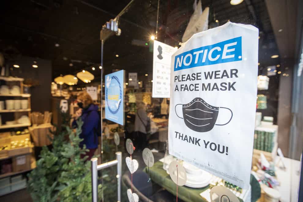 A sign at a shop, advising customers to wear a mask (Liam McBurney/PA)