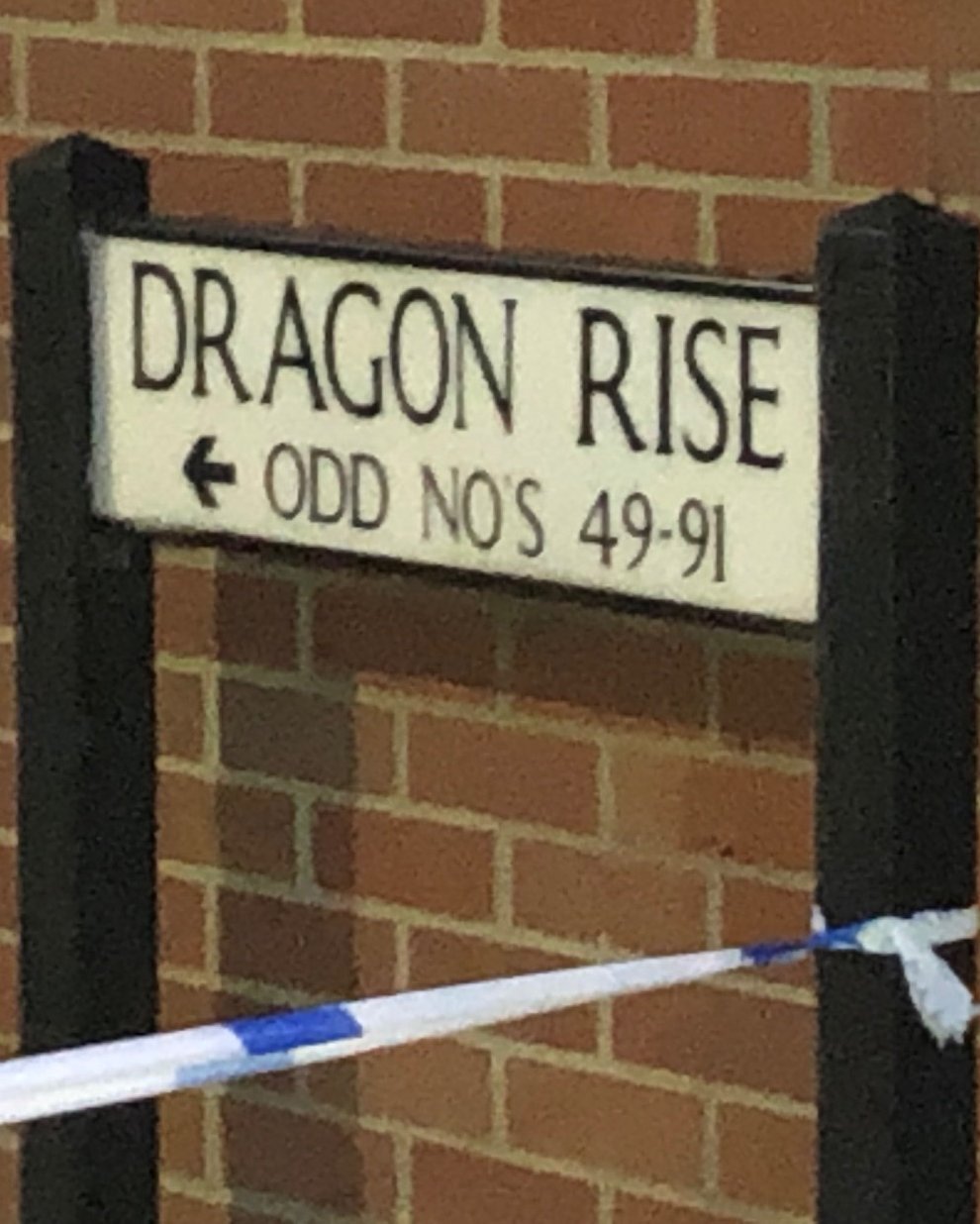 Police tape around the street sign for Dragon Rise in Norton Fitzwarren (Tess De La Mare/PA)