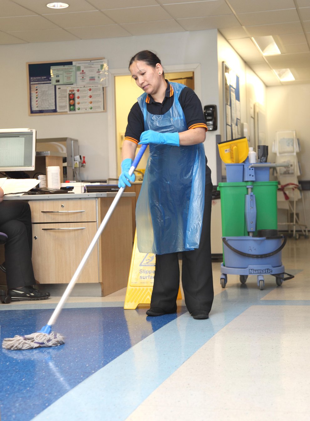 Stock image of a hospital cleaner mopping the floor in a ward in a modern UK hospital (Alamy/PA)