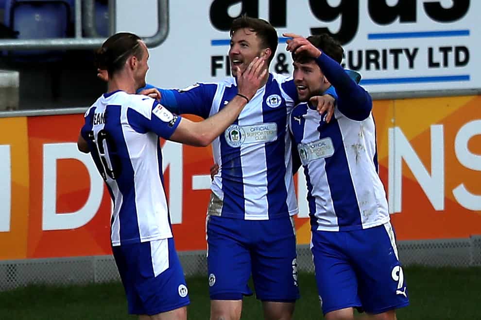 Wigan Athletic’s Callum Lang (right) celebrates scoring their side’s second goal of the game with team-mates Will Keane (left) and Lee Evans during the Sky Bet League One match at the DW Stadium, Wigan. Picture date: Tuesday April 13, 2021.
