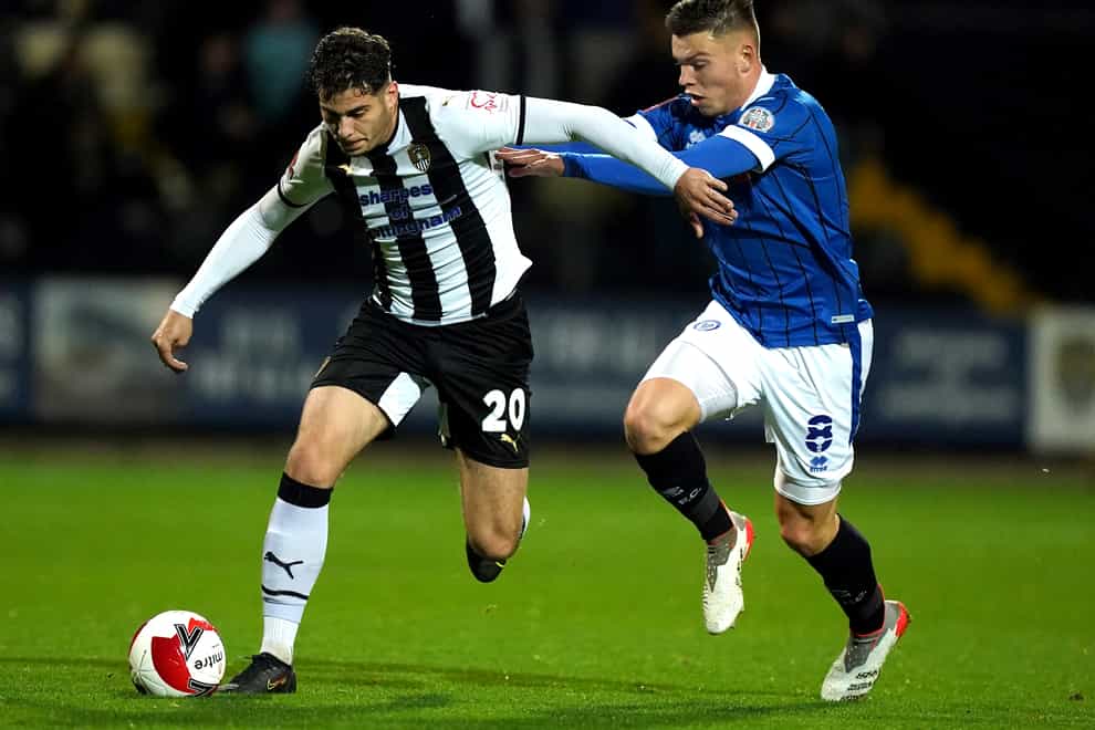 Notts County’s Ruben Rodrigues (left) and Rochdale’s Aaron Morley battle for the ball during the Emirates FA Cup first round replay match at Meadow Lane, Nottingham. Picture date: Tuesday November 16, 2021.