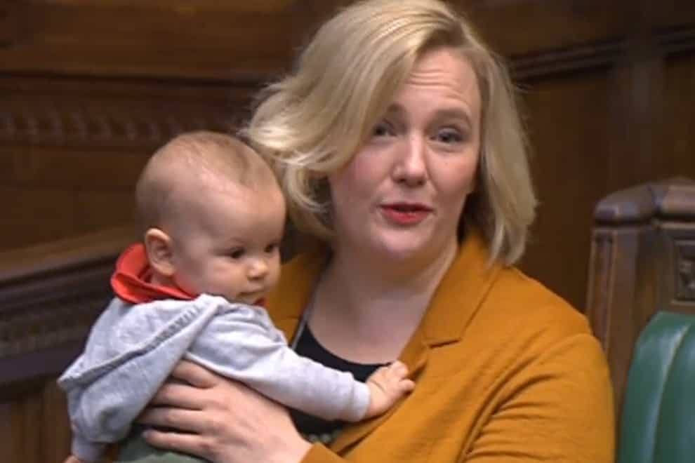 Labour MP Stella Creasy holds her baby daughter in the House of Commons in London as she contributes to a debate (House of Commons/PA)