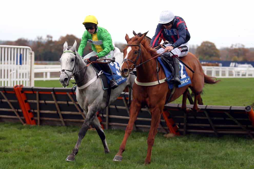 Buzz ridden by jockey Nico de Boinville (left) clear a fence on their way to winning the Coral Hurdle (Registered As The Ascot Hurdle) ahead of Song For Someone and Aidan Coleman (right) (Nigel French/PA)