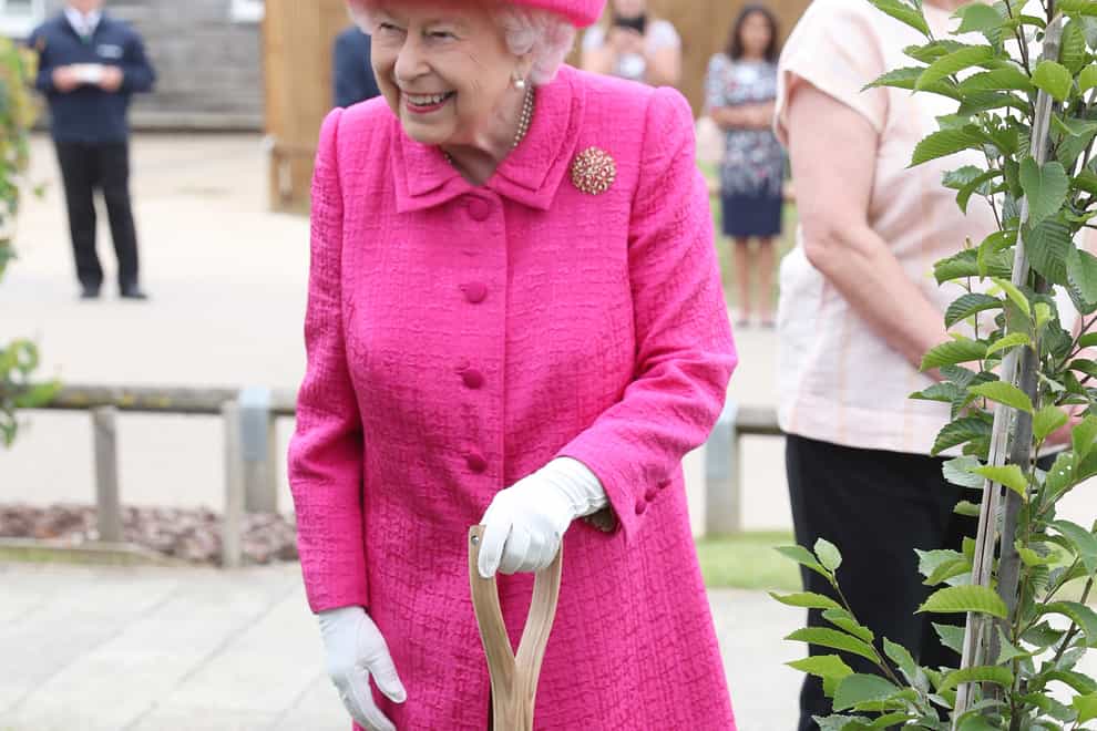 The Queen planted a tree during a visit to the National Institute of Agricultural Botany Park Farm in Cambridge (PA)