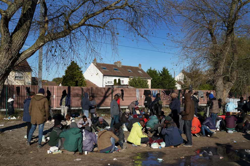 Migrants living at a makeshift camp in Calais (Gareth Fuller/PA)