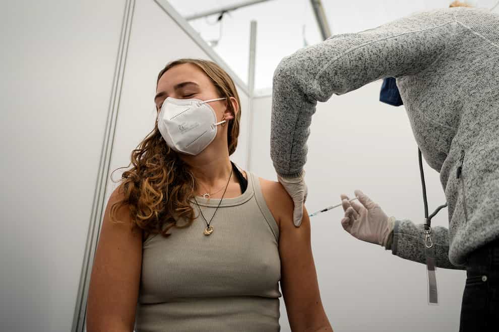 A woman gets her vaccination at a vaccination drive-in centre in Cologne, Germany (Martin Meissner/AP)