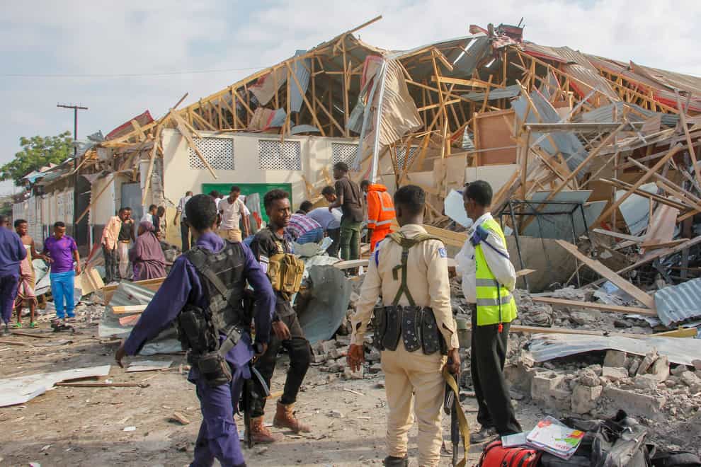 Security forces and rescue workers search for bodies at the scene of the blast in Mogadishu, Somalia (Farah Abdi Warsameh/AP)