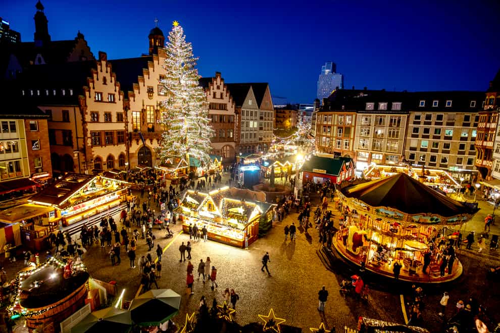 Lights illuminate the Christmas market in Frankfurt, Germany (Michael Probst/AP)