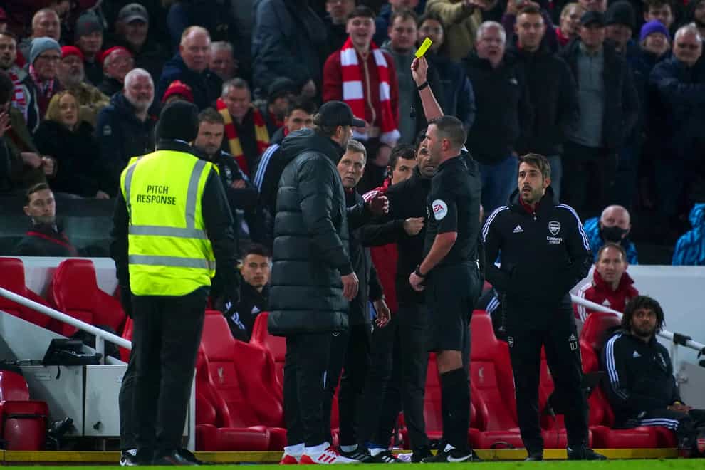 Referee Michael Oliver cautions Arsenal manager Mikel Arteta and Liverpool counterpart Jurgen Klopp after an angry exchange on the sideline (Peter Byrne/PA)