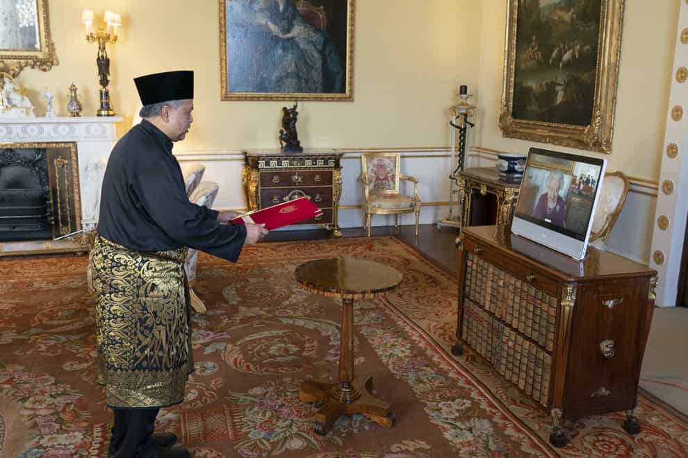 The Queen appears on a screen via video-link from Windsor Castle during a virtual audience to receive the Ambassador of Malaysia Zakri Jaafar (Dominic Lipinski/PA)