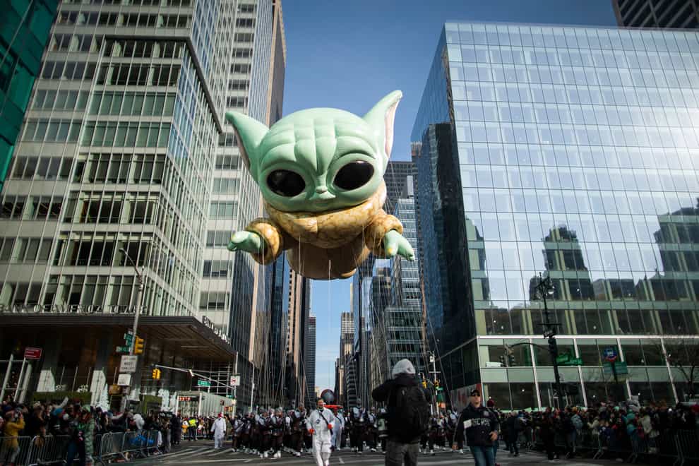 Baby Yoda, also known as the Grogu balloon, floats along Sixth Avenue during the Macy’s Thanksgiving Day Parade in New York (Eduardo Munoz Alvarez/AP)